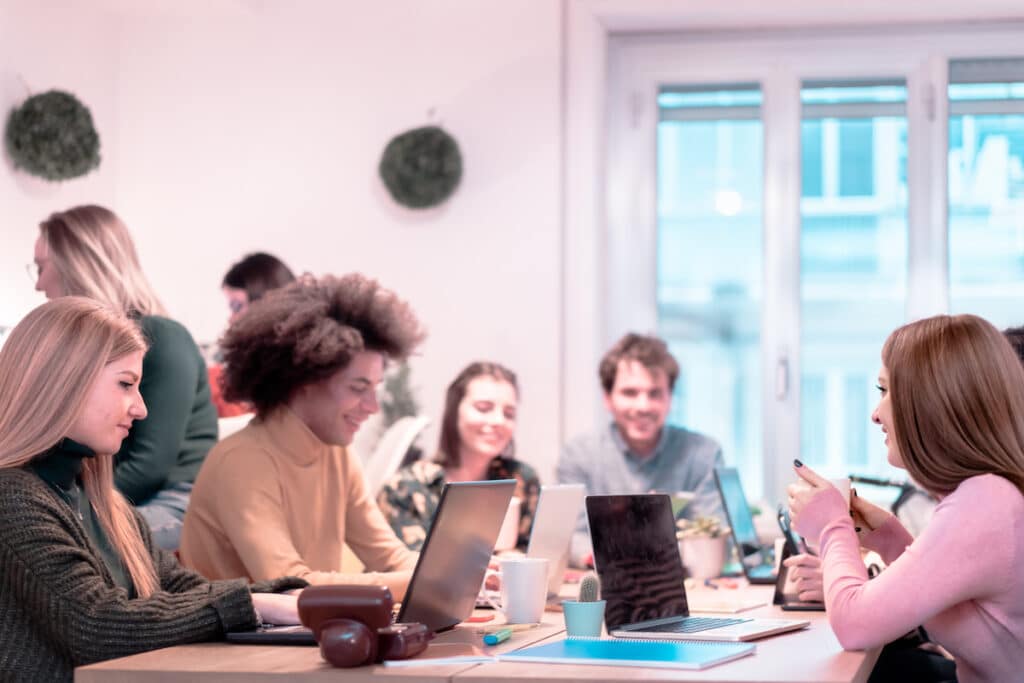 A group of young professionals working from a co-working space.