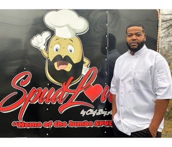 The owner of Spud Love standing in front of his food truck.