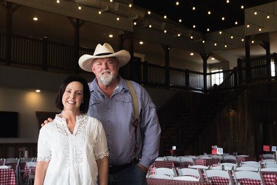 The owners of Rabbit Ridge Farms stand inside a venue.
